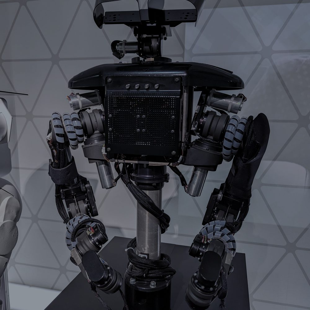 Close-up of a humanoid robot&rsquo;s twin arms and sensor head